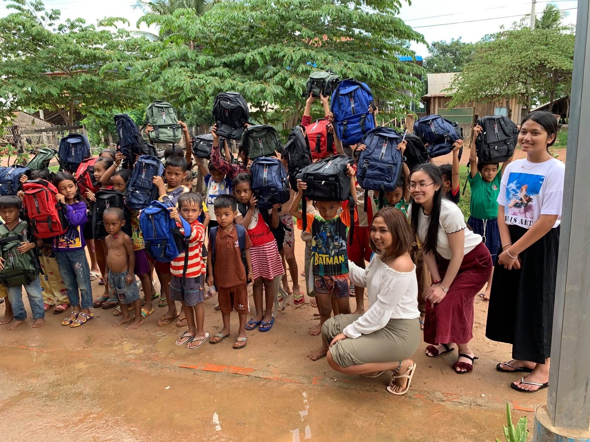 Handing out backpacks to children during the CSS humanitarian trip in Cambodia